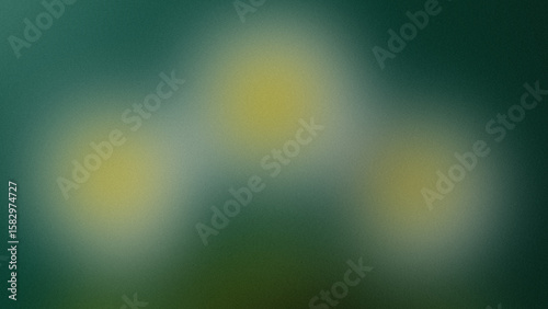 Fotografie Three soft yellow orbs with a grainy texture on a teal background