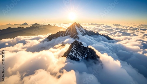 Majestic mountain peak above clouds, sunlight rays breaking through