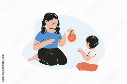Adult Guiding Child in Emotional Learning with Happy Face Card