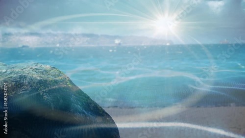 Light ripples drifting over mossy rock and turquoise sea simulating reflections at scene start