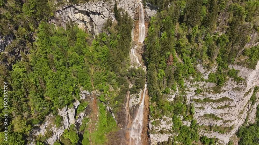 The seerenbach falls in amden, switzerland, surrounded by lush green forest, aerial view The seerenbach falls in amden, switzerland, surrounded by lush green forest, aerial view