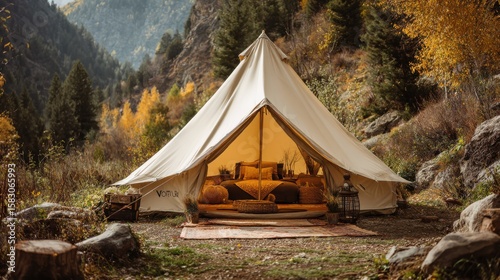 A picturesque glamping tent nestled in a beautiful, secluded woodland setting. It has a spacious interior, furnished with comfortable seating and soft lighting.