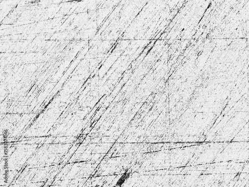 Abstract patterns on a textured surface captured in black and white showing scratches and lines in varying intensity