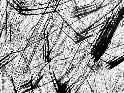 Dynamic black and white abstract art with chaotic strokes and lines on textured surface