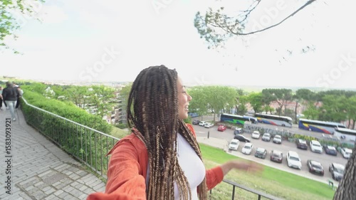 Young woman making a selfie video in a panoramic viewpoint