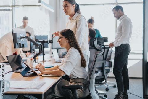 Wallpaper Mural A multicultural group of business people working collaboratively in an open office space. The image captures teamwork, communication, and diversity in a modern workplace setting. Torontodigital.ca