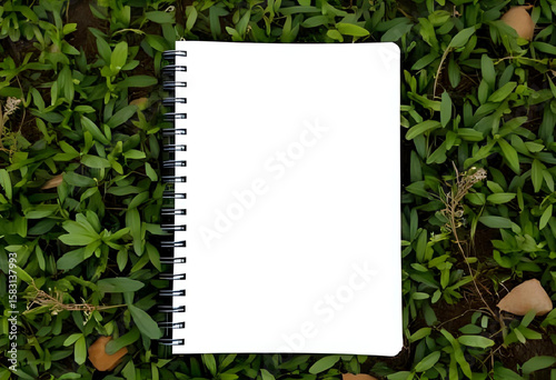 A blank spiral notebook mockup placed on nature background, front cover closed, top-down view, soft natural lighting, perfect for stationery or journaling theme.