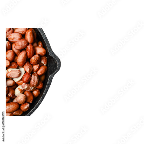 Raw unsalted peanuts with red skin in a black cast iron skillet on transparent background natural snack food ingredient