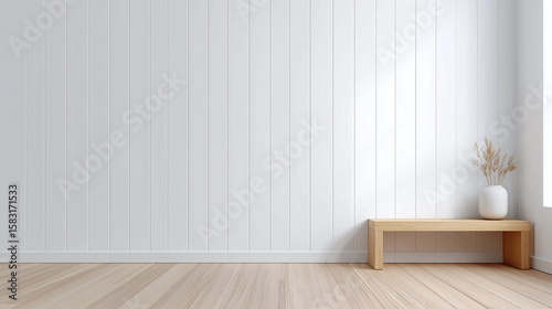 Minimalist interior with white wood panel wall and light wooden bench holding white vase with dried plants, natural light creating calm and clean atmosphere
