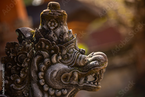 Old sculpture fully covered with green moss in Bali, Indonesia