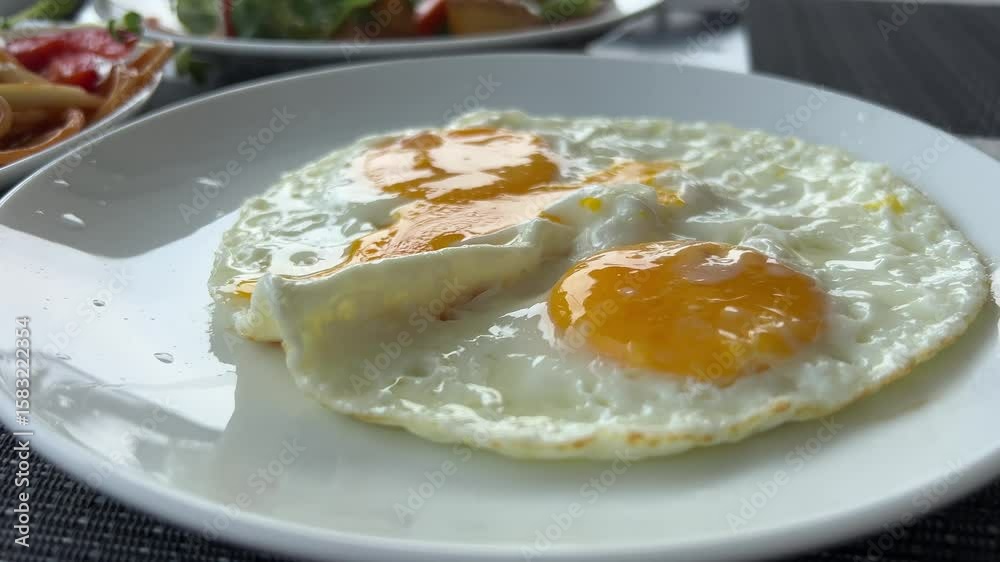 two Fried eggs in the plate close up ,. High quality 4k footage two Fried eggs in the plate close up ,. High quality 4k footage