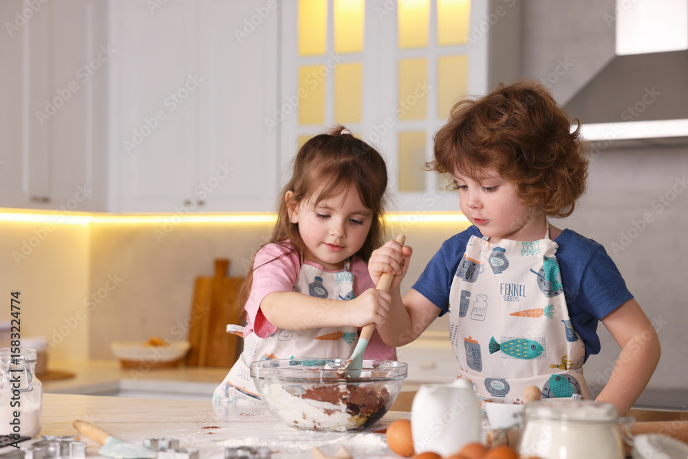 Cooking recipe. Cute children mixing dough for cookies at table in kitchen Cooking recipe. Cute children mixing dough for cookies at table in kitchen