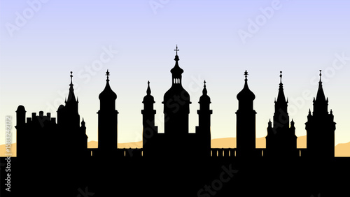 Silhouette of a city skyline with various towers and spires against a gradient sky at dusk or dawn