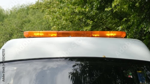 Emergency signal lights on the roof of a special vehicle, cyclically flashing and going out. Emergency lights are yellow.