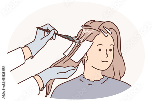 Woman getting hair dyed by professional hairdresser making stylish hairstyle for going to party