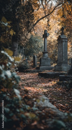 Autumn cemetery path with fallen leaves and historic tombstones