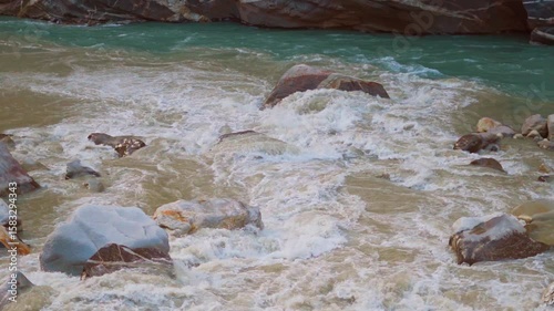Slow motion shot of confluence of Spiti river and Sutlej river at Khab Sangam near Khab village in Kinnaur, Himachal Pradesh, India. Beautiful scenic view of two rivers merging in the Himalayas.