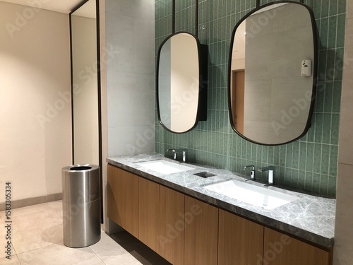 Interior of modern restroom with white wall and warm light. Row of sanitary ware with men urinals in public toilet.	