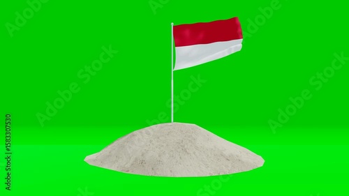Indonesian flag planted on a sand pile with green screen background.