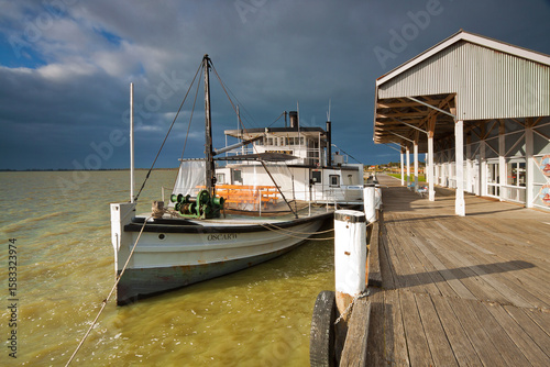 A paddle steamer beside a wharf