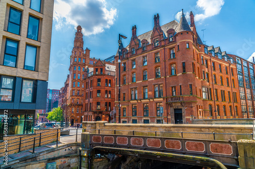 A view past a road bridge over canal street  in Manchester,UK in summertime