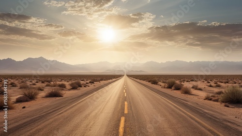 Desert road stretching into the horizon with heat haze and dry cracked terrain