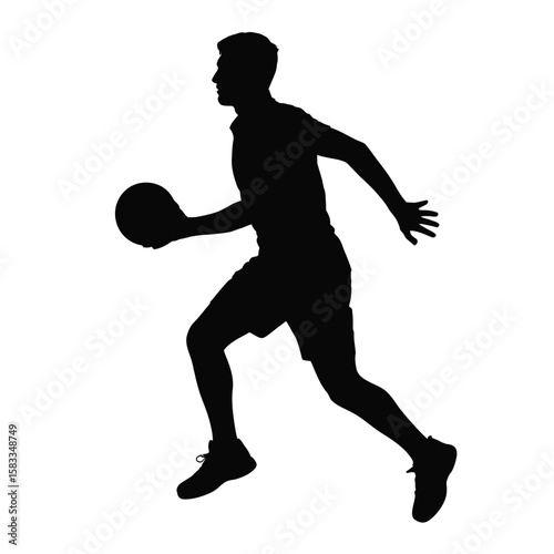 Silhouette of a male basketball player dribbling the ball while running