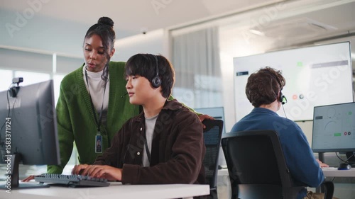 Business meeting at tech support call center showcasing teamwork with headsets and computers in modern office environment providing efficient call center support and collaboration