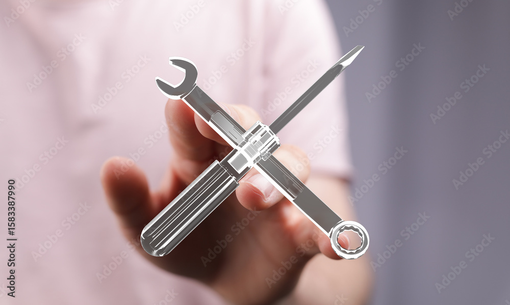 Obraz premium Image of a hand holding a digital graphic of crossed wrench and screwdriver tools, symbolizing repair, maintenance, or technical support.