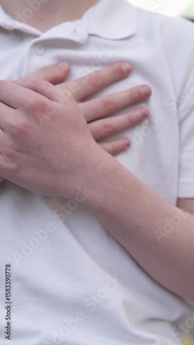 Teenager feels sharp pain in heart after school bullying. Concepts of heart failure, stress and panic attack. Vertical video.