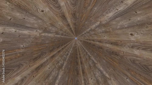 Spinning animation of radial wooden grain surface.