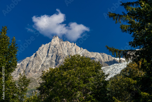 Chamonix valley landscape of a prominent rocky towering mountain peak Aiguille du Midi in French Alps. Chamonix-Montblanc area, Tour du Montblanc beautiful landscape Aiguille du Midi summit, France