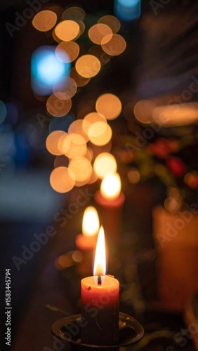 Burning Candle with Warm Glow and Bokeh Lights