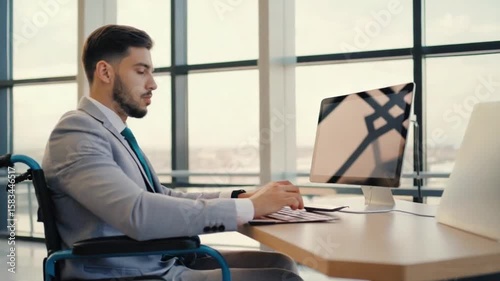 In a sleek office setting, a young professional confidently navigates his work while utilizing a wheelchair. The expansive windows reveal a vibrant urban landscape, symbolizing ambition