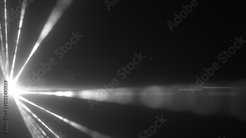 Fotografie Black-and-white laser beams radiating from a blinding light source in the dark