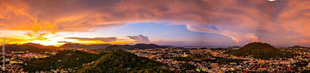 Fototapeta premium aerial view of Khao Rang viewpoint in sunset. Khao Rang viewpoint tower landmark in Phuket town it is on Tung Ka hill. on Khao Rang viewpoint can see around Phuket and watching sunrise and sunset