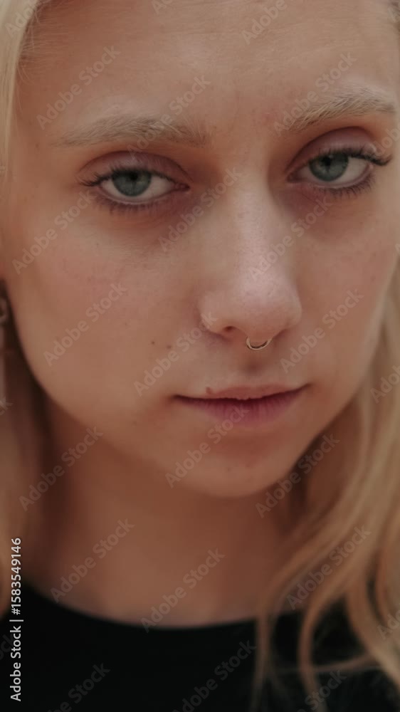 Vertical video, Serious Young Blonde Woman in a Close Up Vertical video, Serious Young Blonde Woman in a Close Up
