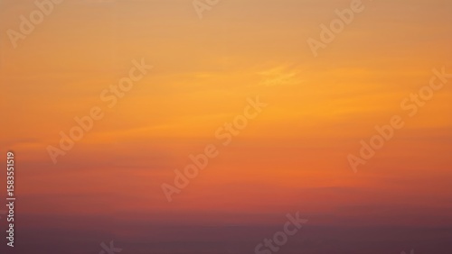 Soft-focused picture of a multicolored sunset with gradient tones blending yellow into purple.
