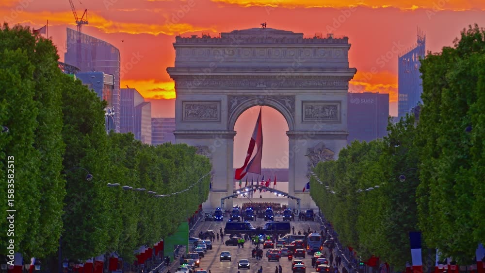 Arc de Triomphe against the backdrop of a beautiful sunset. French flag in the wind in the triumphal arch. Paris, France