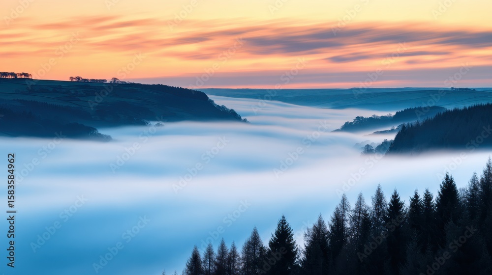 Fototapeta premium Serene misty landscape at dawn, showcasing valleys and forests under a colorful sky