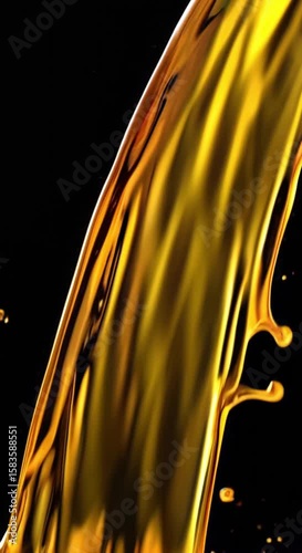Slow Motion Pouring Of Viscous Golden Liquid On Black Background Creates Abstract Art