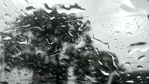 Raindrops on the glass of the window. Stormy, inclement, rainy weather.