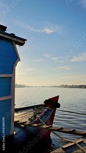 Traditional wooden boats on the river create a beautiful morning on the horizon under a bright blue sky