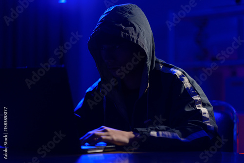 Hacker launching cyberattack targeting data systems and exposing cybersecurity vulnerabilities