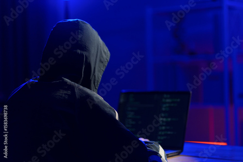 Hacker launching cyberattack targeting data systems and exposing cybersecurity vulnerabilities