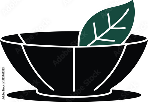 Stylized black bowl with a single green leaf and white accents