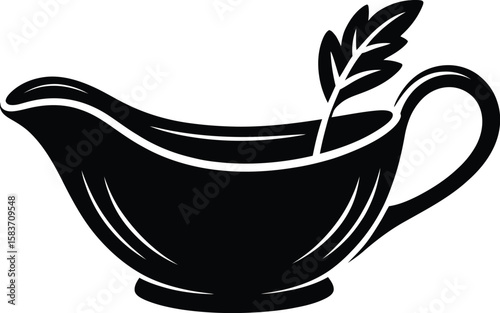 Stylized black gravy boat with a single leaf garnish