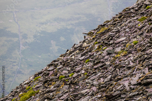 Rugged Pile of Slate Rubble with a Hazy Mountain Valley Background