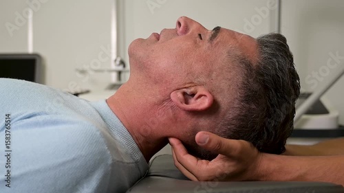 adult male on the examination table of a specialist physiotherapist's clinic