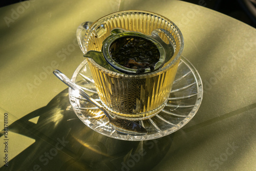 Serene Green Tea in Glass Cup Bathed in Sunlight
